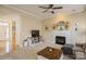 Comfortable living room with a fireplace, plush sofa, and a view into the adjacent kitchen at 6816 Charter Hills Rd, Charlotte, NC 28277