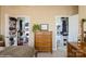 Cozy main bedroom featuring and walk-in closets and a dresser with a beautiful plant on top at 6816 Charter Hills Rd, Charlotte, NC 28277
