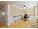 Well-lit home office with hardwood floors, wainscoting, a ceiling fan, and a large window at 6816 Charter Hills Rd, Charlotte, NC 28277