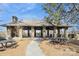 Community pavilion featuring stone columns, ceiling fans, picnic tables, and grilling stations at 6816 Charter Hills Rd, Charlotte, NC 28277