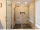 A modern bathroom with a glass-enclosed walk-in shower, beautiful tile and updated fixtures at 6816 Charter Hills Rd, Charlotte, NC 28277