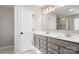 Bright bathroom features a double sink vanity with neutral cabinets, a large mirror, and tiled floors at 838 Foxglove Ln, York, SC 29745