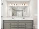 Bright bathroom features a double sink vanity, a large mirror, and modern lighting fixtures at 838 Foxglove Ln, York, SC 29745