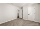 Bright bedroom featuring neutral walls, carpet, and an open doorway at 838 Foxglove Ln, York, SC 29745