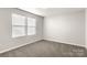 Bright bedroom with two windows, neutral walls and plush carpeting at 838 Foxglove Ln, York, SC 29745