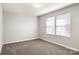 A bright bedroom features plush carpeting and two large windows with lots of natural light at 838 Foxglove Ln, York, SC 29745