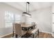 Bright dining room with a large wooden table, seating for six, and a modern chandelier at 838 Foxglove Ln, York, SC 29745