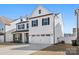 Charming two-story home with black shutters, neutral siding, and a two-car garage at 838 Foxglove Ln, York, SC 29745