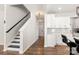 Hallway with stairs and eat-in kitchen area, featuring dark wood floors and open design at 838 Foxglove Ln, York, SC 29745