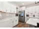 Modern kitchen featuring white cabinets, stainless steel appliances, quartz countertops, and hardwood floors at 838 Foxglove Ln, York, SC 29745