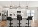Modern kitchen featuring an island with barstool seating, stainless appliances, and white cabinetry at 838 Foxglove Ln, York, SC 29745