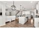 Open-concept living and kitchen area with hardwood floors, modern light fixtures, and seamless flow at 838 Foxglove Ln, York, SC 29745