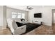 Cozy living room with a white recliner sectional, a black shag rug, and a modern ceiling fan at 838 Foxglove Ln, York, SC 29745
