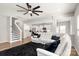 Open-concept living area with modern finishes, including a sectional, and a view of the kitchen and staircase at 838 Foxglove Ln, York, SC 29745