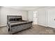 The main bedroom includes carpet floors and a stylish gray velvet bed next to an ensuite bathroom at 838 Foxglove Ln, York, SC 29745