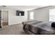 The main bedroom features carpet floors, a TV, natural light, and a stylish gray velvet bed at 838 Foxglove Ln, York, SC 29745