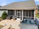 Outdoor living featuring screened porch, hot tub, and grilling area for relaxing and entertaining at 10159 Lakeshore Dr, Lancaster, SC 29720