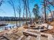 Lakeside backyard features a stone fire pit and water access at 10159 Lakeshore Dr, Lancaster, SC 29720