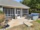 Relaxing backyard with a screened porch, hot tub, stainless steel grill, and outdoor seating area at 10159 Lakeshore Dr, Lancaster, SC 29720