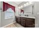 Bathroom with double sink vanity, granite countertop, wood cabinets, and large mirror at 10159 Lakeshore Dr, Lancaster, SC 29720