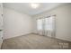 Bright bedroom features neutral carpet, fresh paint, and natural light from the windows at 10159 Lakeshore Dr, Lancaster, SC 29720