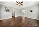 Spacious bedroom with hardwood floors, neutral walls, ceiling fan, and two entryway doors at 10159 Lakeshore Dr, Lancaster, SC 29720