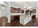 Open-concept kitchen with stainless steel appliances, dark wood cabinets, and hardwood flooring at 10159 Lakeshore Dr, Lancaster, SC 29720