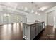 Kitchen island in open floor plan with hardwood flooring and bright natural lighting at 10159 Lakeshore Dr, Lancaster, SC 29720