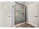 Bathroom featuring walk-in shower with gray tile and shower door at 10159 Lakeshore Dr, Lancaster, SC 29720