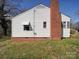 Side view of a white house with a brick chimney at 1043 Ridge Ave, Gastonia, NC 28052