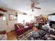 Bright living room with a fireplace, wood floors, a ceiling fan, a decorative mirror, and two cozy armchairs at 1043 Ridge Ave, Gastonia, NC 28052