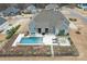 Aerial view of the home's backyard featuring a pool, spa, patio, landscaping, and a fenced-in yard at 107 Hillside Cove Ct, Mooresville, NC 28117