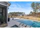 Relaxing backyard oasis with a sparkling pool, lounge chairs, and lush greenery at 107 Hillside Cove Ct, Mooresville, NC 28117
