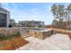 An inviting pool area with travertine patio and steps, surrounded by manicured landscaping at 107 Hillside Cove Ct, Mooresville, NC 28117