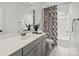 Contemporary bathroom featuring shower and tub, gray vanity, and modern fixtures at 107 Hillside Cove Ct, Mooresville, NC 28117
