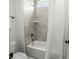 Cozy bathroom featuring shower and tub with gray tiling and modern fixtures at 107 Hillside Cove Ct, Mooresville, NC 28117