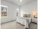 Well-lit bedroom with large windows, neutral walls, carpeting, a bed and side table, and a ceiling fan at 107 Hillside Cove Ct, Mooresville, NC 28117