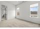 Sunlit bedroom features neutral walls, plush carpeting, double windows and an open door to an en suite at 107 Hillside Cove Ct, Mooresville, NC 28117