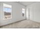 Bright bedroom features plush carpeting, neutral walls, a double window, and a white door at 107 Hillside Cove Ct, Mooresville, NC 28117