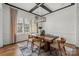 Elegant dining room with coffered ceilings, stylish light fixture, and a wooden table perfect for gatherings at 107 Hillside Cove Ct, Mooresville, NC 28117