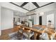 Open concept dining room with hardwood floors, modern lighting, and seamless flow to other living spaces at 107 Hillside Cove Ct, Mooresville, NC 28117