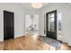 Bright foyer features hardwood floors, a black door, and an adjacent office space at 107 Hillside Cove Ct, Mooresville, NC 28117