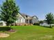 Beautiful home with lush lawn, stone accents, and mature trees in a desirable neighborhood at 107 Hillside Cove Ct, Mooresville, NC 28117