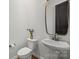Chic half bathroom featuring a modern sink, dark door, and stylish fixtures for guests' convenience at 107 Hillside Cove Ct, Mooresville, NC 28117