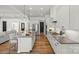 Bright, modern kitchen with sleek appliances, white cabinetry, and open access to the living room and dining area at 107 Hillside Cove Ct, Mooresville, NC 28117