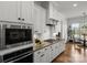 Well-equipped kitchen features stainless steel appliances, light wood floors, and an adjoining breakfast nook at 107 Hillside Cove Ct, Mooresville, NC 28117