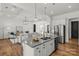 Open-concept kitchen with island seating, stainless steel appliances, and seamless flow to the living area at 107 Hillside Cove Ct, Mooresville, NC 28117