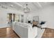 Bright living room boasts modern lighting, sleek white walls, and sliding door access to the outdoor space at 107 Hillside Cove Ct, Mooresville, NC 28117