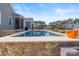A luxurious backyard featuring a beautiful pool with stone accents and a serene outdoor setting at 107 Hillside Cove Ct, Mooresville, NC 28117