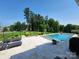 An in-ground pool, outdoor seating, patio, and lush trees highlight the outdoor living of this home at 107 Hillside Cove Ct, Mooresville, NC 28117